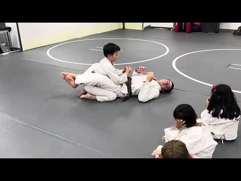 Two hands on one control from guard bottom