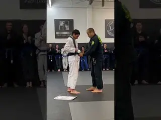 Prof. Leka getting promoted to 6th degree Black Belt by Master Leo Vieira